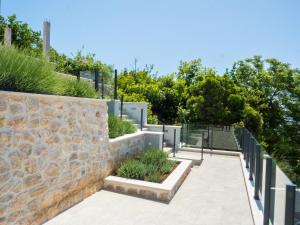 a stone wall next to a courtyard with plants at Apartments Bella Vista - Mlini in Mlini