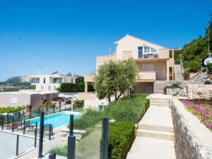 a villa with a swimming pool and a house at Apartments Bella Vista - Mlini in Mlini