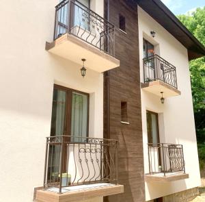 a house with balconies on the side of it at Апартамент МИТИ in Pleven