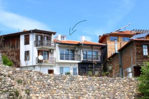 a group of houses behind a stone wall at Villa Apollonia in Sozopol
