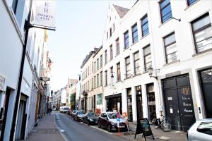 a street with cars parked on the side of a building at The Antwerp Old Town Lodge in Antwerp