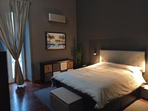 a bedroom with a large bed and a window at HOUSE of COLORS in Bari