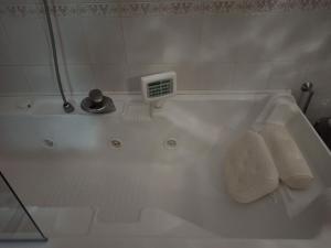 a white bath tub with two towels in a bathroom at HOUSE of COLORS in Bari