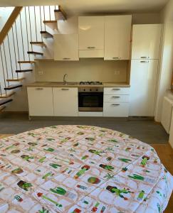a kitchen with a large bed in a room at L'angolo di Giulia in Castelletto di Brenzone +10 photos