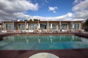 a swimming pool in front of a building at Palacio del Sol Luxury Apartments in Nafplio
