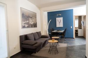 a living room with a couch and a table at Aparthotel Menden in Menden