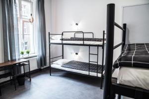a bedroom with two bunk beds and a window at Chopin Host in Katowice