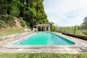 a swimming pool with a gazebo in a backyard at Quinta da Agraceira Casa do Caseiro in Vila Nova de Gaia