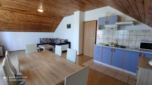 a kitchen and living room with a table and a dining room at Apartment Nikolina in Grabovac
