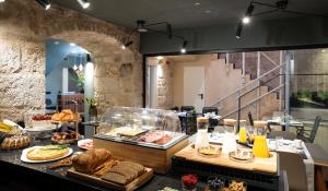 a restaurant with a buffet of food on a table at Camera Hotel in Split