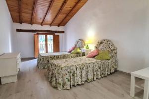 a bedroom with two beds and a table and a window at JERICA ALOHA in Jérica