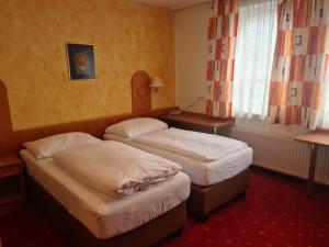 A bed or beds in a room at Hotel Wirt im Feld