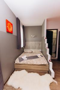 a bedroom with a bed and a rug at Затишні Apartments in Ivano-Frankivsʼk