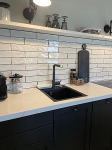 a kitchen with a sink and a counter top at Strandhus in Rantum