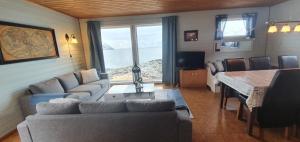 a living room with a couch and a table at Arctic FjordCamp in Burfjord