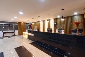 a lobby with a bar in a building at Fênix Hotel Moema in Sao Paulo