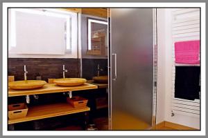 a bathroom with two sinks and a shower at LES CHAMBRES DE LIANE in Cerdon +55 photos