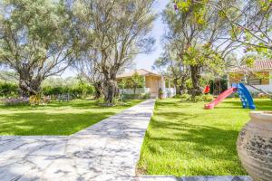 a yard with a playground with a slide at Villa Hector in Lefkada Town