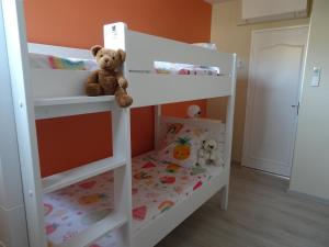 a white bunk bed with a teddy bear sitting on it at T3 150 m de la plage, climatisation, piscine et parking privatif - Le Lavandou in Le Lavandou