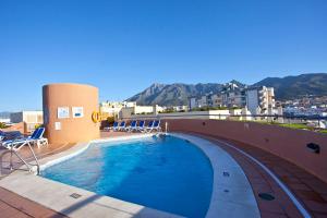 a swimming pool on top of a building with mountains in the background at Ona Princesa Playa in Marbella