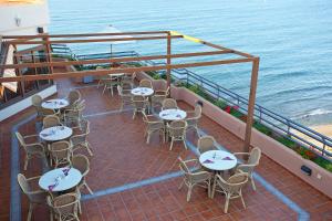 a balcony with tables and chairs and the ocean at Ona Princesa Playa in Marbella