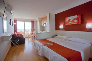 a hotel room with a large bed with a red wall at Ona Princesa Playa in Marbella