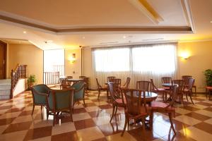 a restaurant with tables and chairs and a checkered floor at Ona Princesa Playa in Marbella