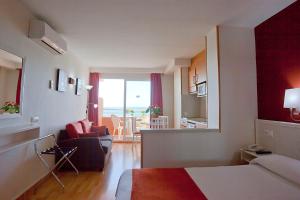 a bedroom with a living room and a living room with a couch at Ona Princesa Playa in Marbella