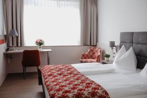 Ένα ή περισσότερα κρεβάτια σε δωμάτιο στο Stadtoase Kolping Hotel