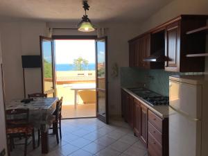 a kitchen with a table and a view of the ocean at Casa Vacanza Chiara in Tropea