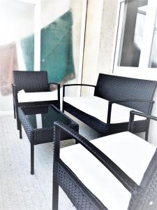 a group of chairs and tables on a balcony at Apartament a la Costa Brava l'Estartit - MyAnna in L'Estartit