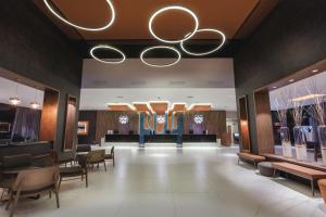 a lobby of a fashion store with tables and chairs at Hotel Riu Costa del Sol - All Inclusive in Torremolinos