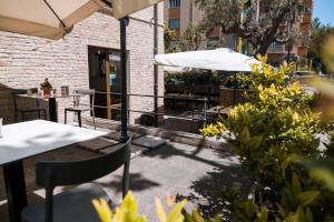 a patio with tables and chairs and umbrellas at B&B Palazzo Storico Di Nicola in Pescara