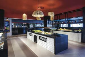 a restaurant kitchen with a buffet of food at Hotel Riu Costa del Sol - All Inclusive in Torremolinos