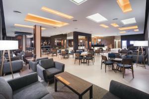 a lobby of a hotel with chairs and tables at Hotel Riu Costa del Sol - All Inclusive in Torremolinos