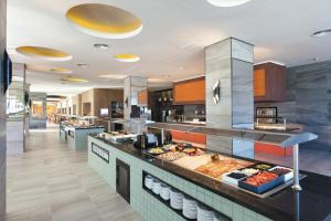 a buffet line in a restaurant with food at Hotel Riu Costa del Sol - All Inclusive in Torremolinos