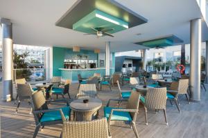 a restaurant with chairs and tables and a ceiling at Hotel Riu Costa del Sol - All Inclusive in Torremolinos