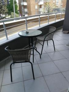 a table and two chairs sitting on a balcony at Апартамент за гости Соня Guest Apartment Sonya in Nesebar