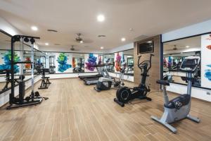 a gym with treadmills ellipticals and exercise bikes at Hotel Riu Costa del Sol - All Inclusive in Torremolinos