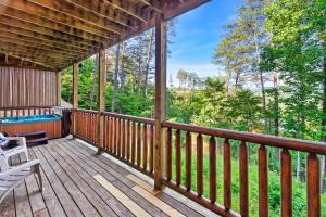 a cabin with a deck with a view of the woods at Getaway Cabin, 360 Deck, Theater, HotTub, Mins to PF in Sevierville