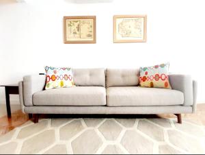 a couch with two pillows on it in a living room at Casa do Arco by HnM in Tavira