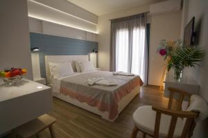 a hotel room with a bed with towels on it at Eleni Studios Parga in Parga