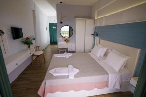 a bedroom with a large bed with towels on it at Eleni Studios Parga in Parga