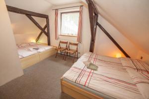 a bedroom with two twin beds and a window at Horská chata Hubert in Bedřichov +102 photos