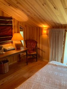 a bedroom with a desk and a chair and a lamp at Le Potala in Le Bouchet-Saint-Nicolas