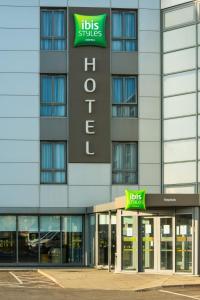 a building with a hilton hotel sign in front of it at ibis Styles Haydock in Haydock