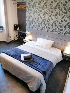 a bedroom with a bed with a blue blanket on it at B&B IL SOGNO in Turin