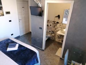 a bathroom with a bed and a toilet and a sink at B&B IL SOGNO in Turin