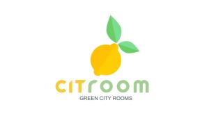 an orange fruit with a leaf on top of it at Citroom - green city rooms in Olbia