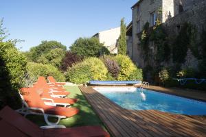 a group of chairs sitting next to a swimming pool at La Clavelière in Saint-Auban-sur-lʼOuvèze